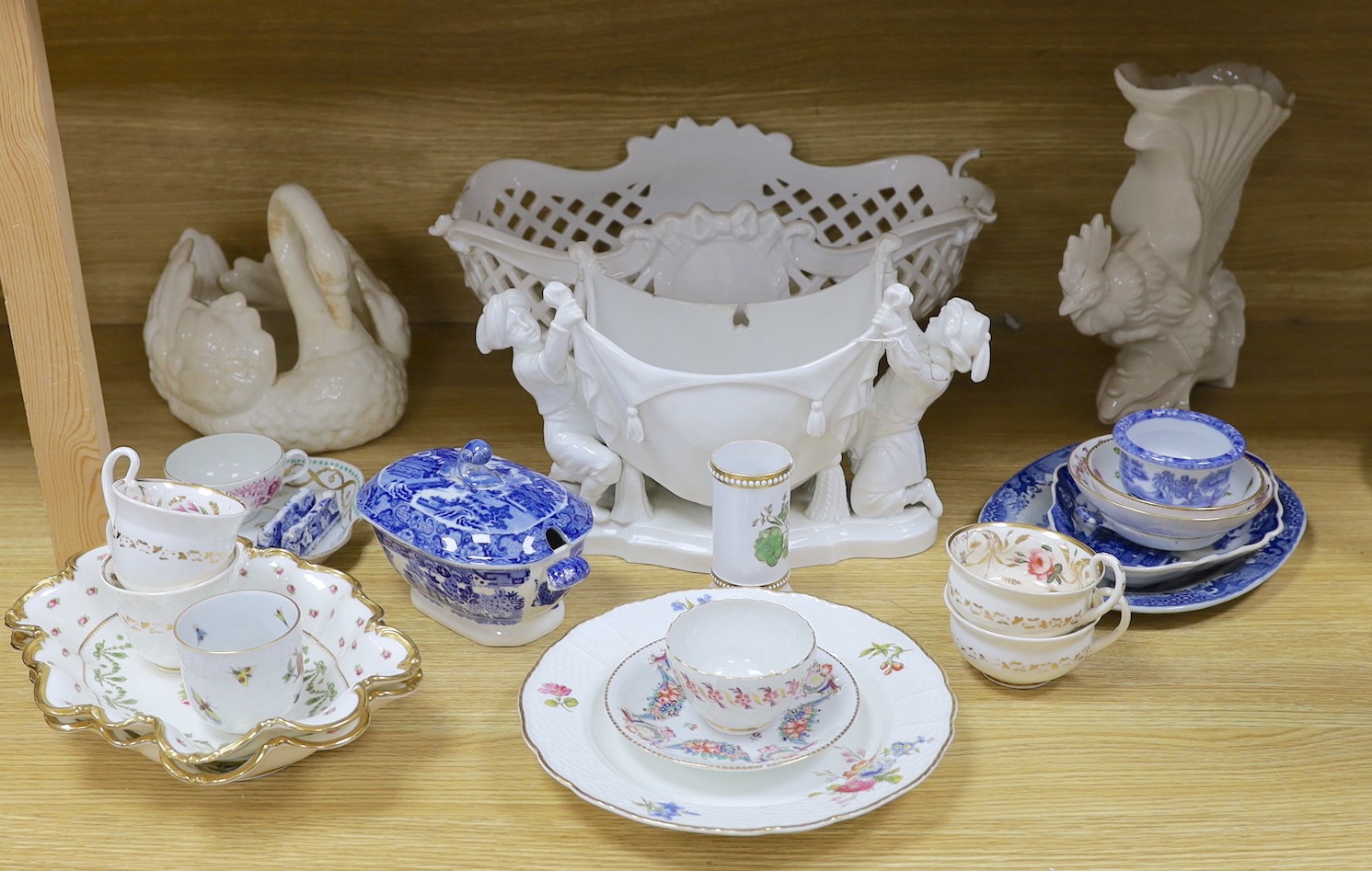 A group of Staffordshire blue and white pottery, including a sauce tureen and cover, together with a selection of decorative tea and dessert wares and ceramic centrepieces, one modelled as a cockerel